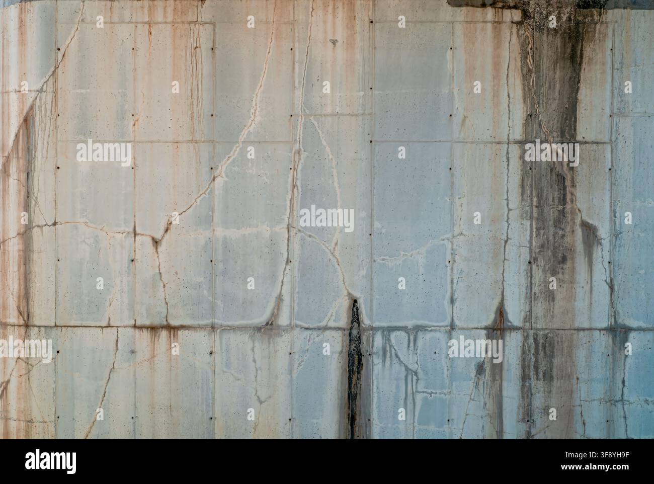 Abstract grunge background: large orthogonal concrete texture. The surface of a railway bridge pylon. Cracks, dripping traces, and the formwork imprin Stock Photo