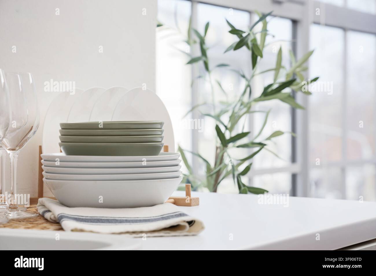 Stack of clean dishes on counter in kitchen Stock Photo