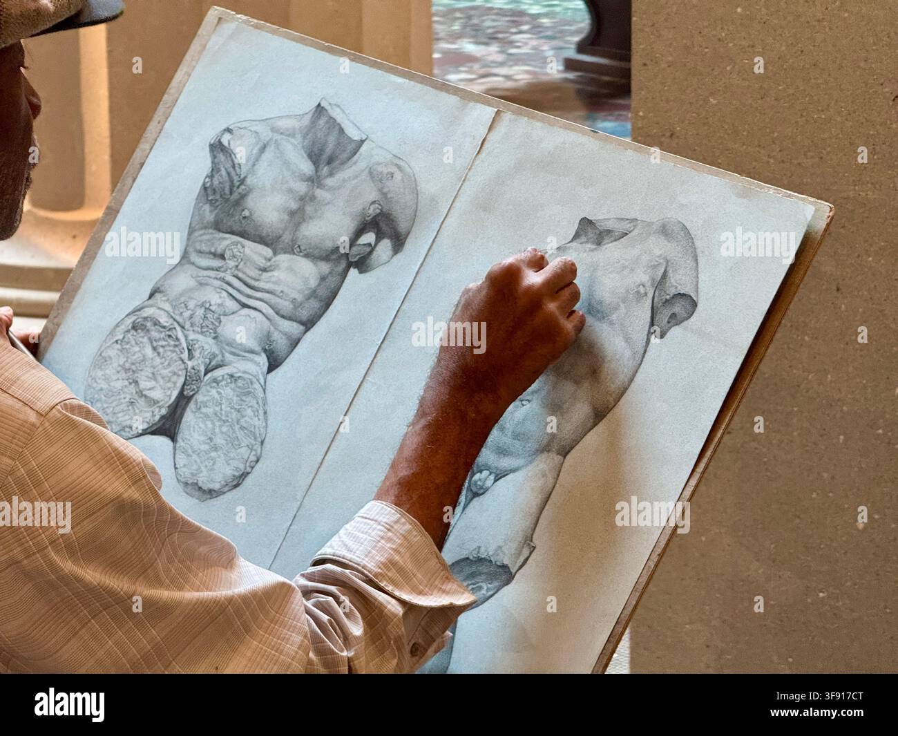 Older Gentleman Sketching in the Greek and Roman Gallery of the Metropolitan Museum of Art in New York City - Smartphone Captured Stock Image