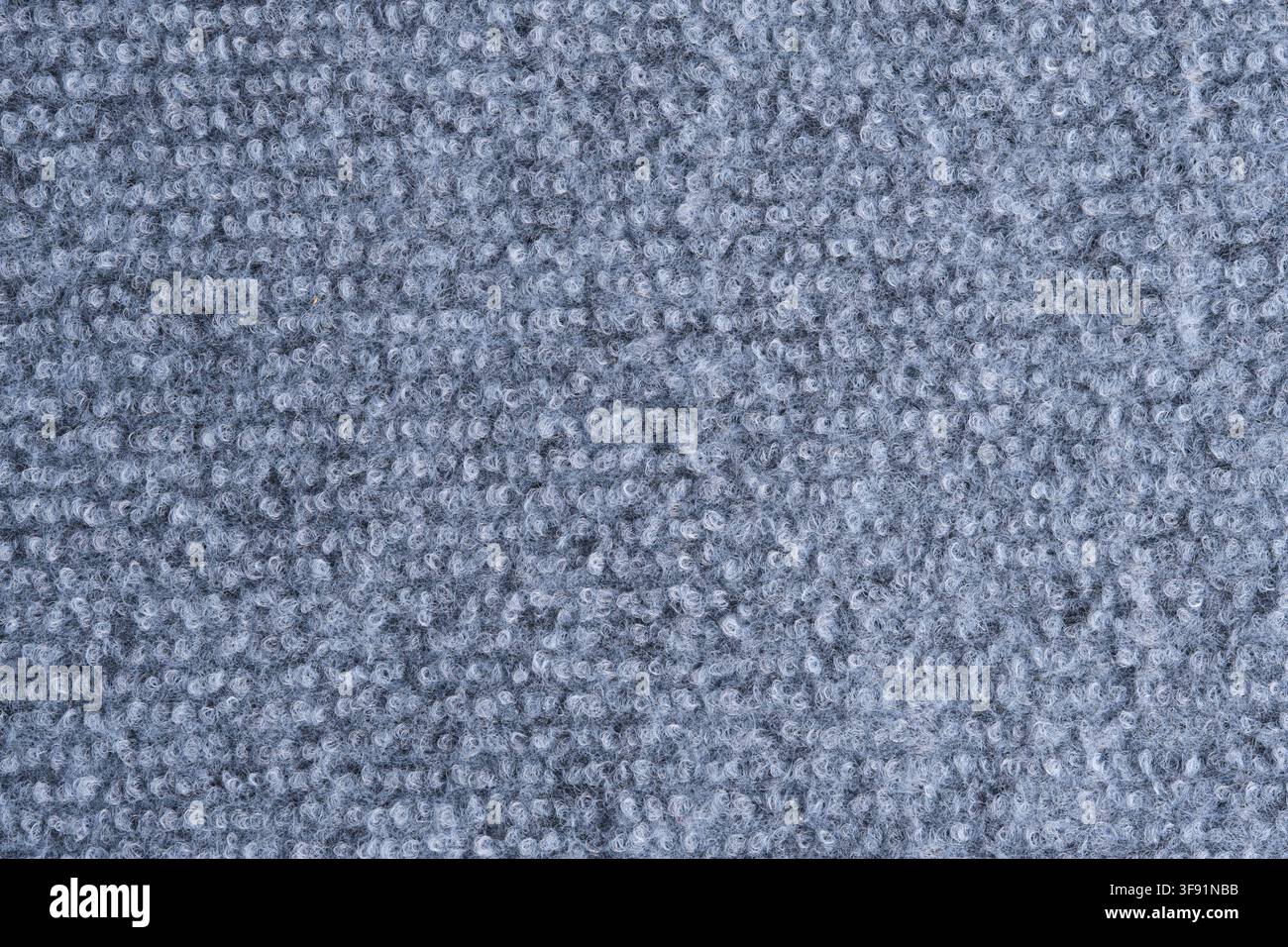 Seamless grey loop pile carpet texture background, offering soft woven fabric surface macro view Stock Photo