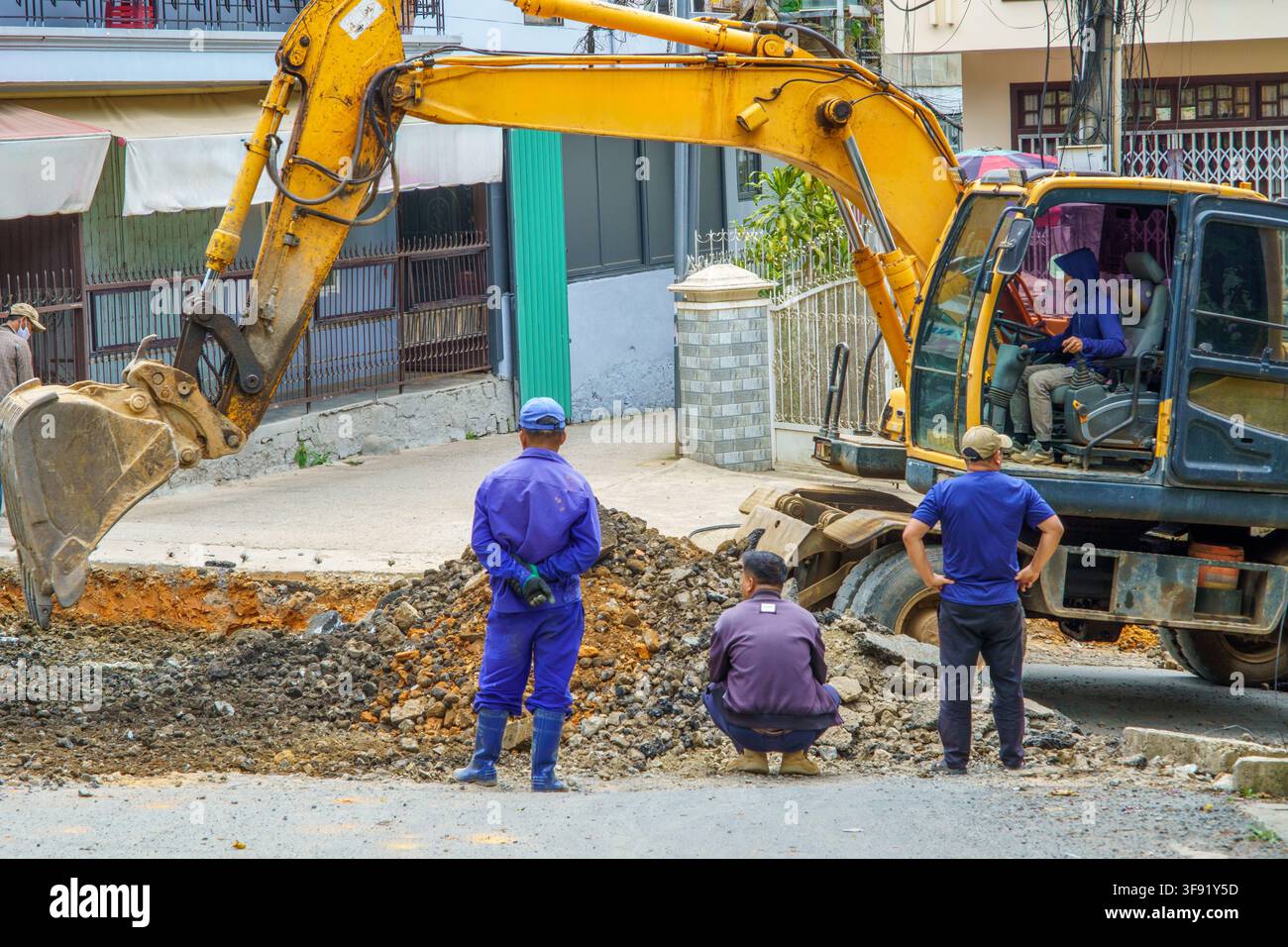 Construction workers inspecting excavation site. Stock Photo