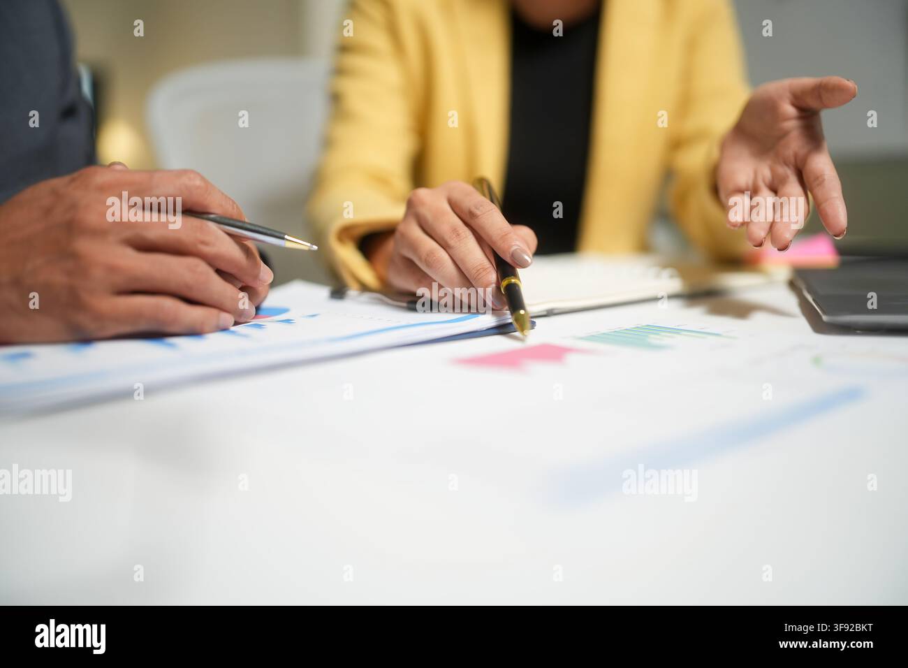 Business team reviewing charts in meeting Stock Photo
