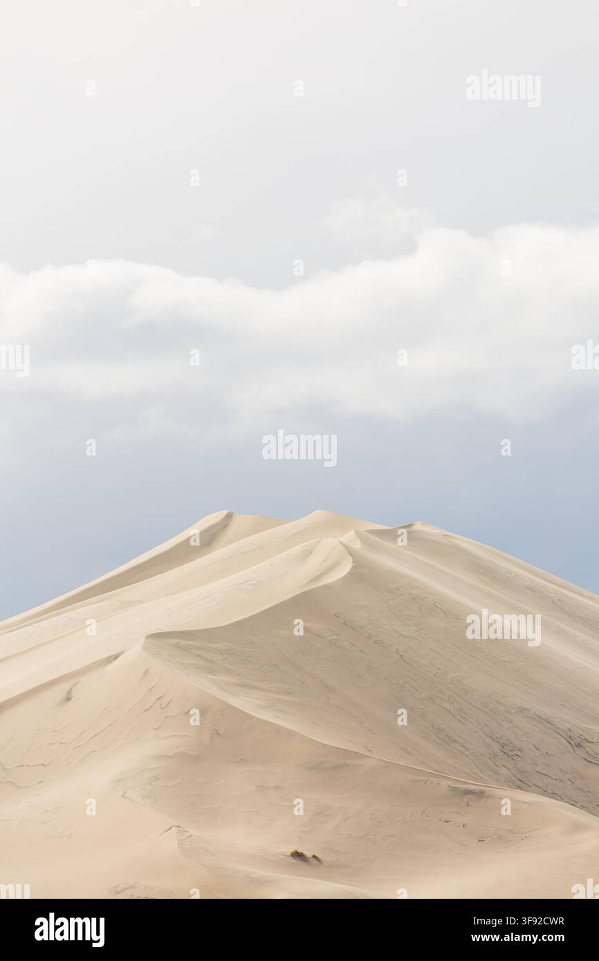 Pale sand dunes under a soft cloudy sky Stock Photo