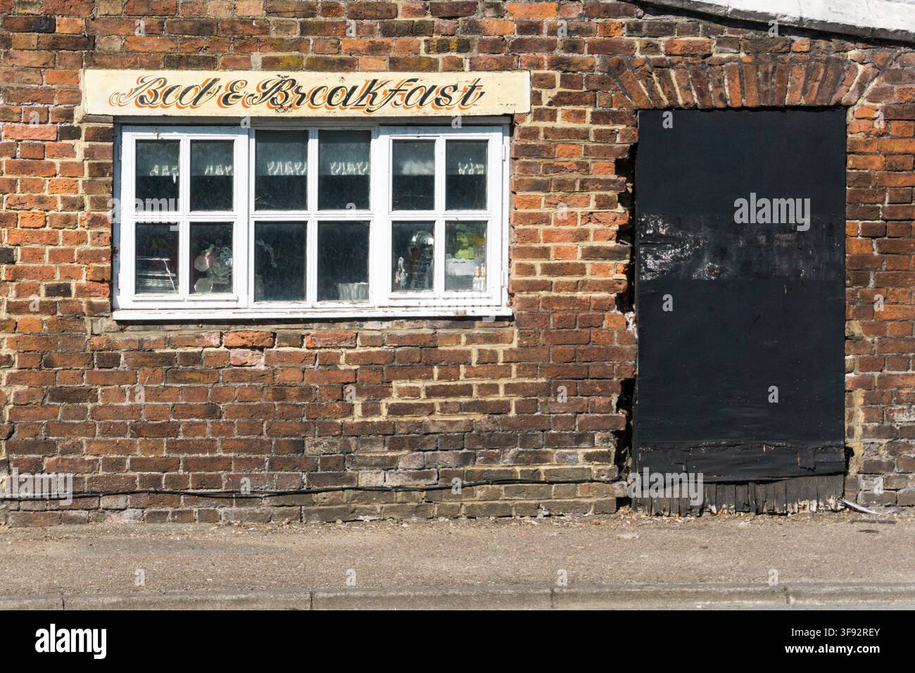 Bed & Breakfast sign over the window of an old building in King's Lynn, Norfolk. Stock Photo