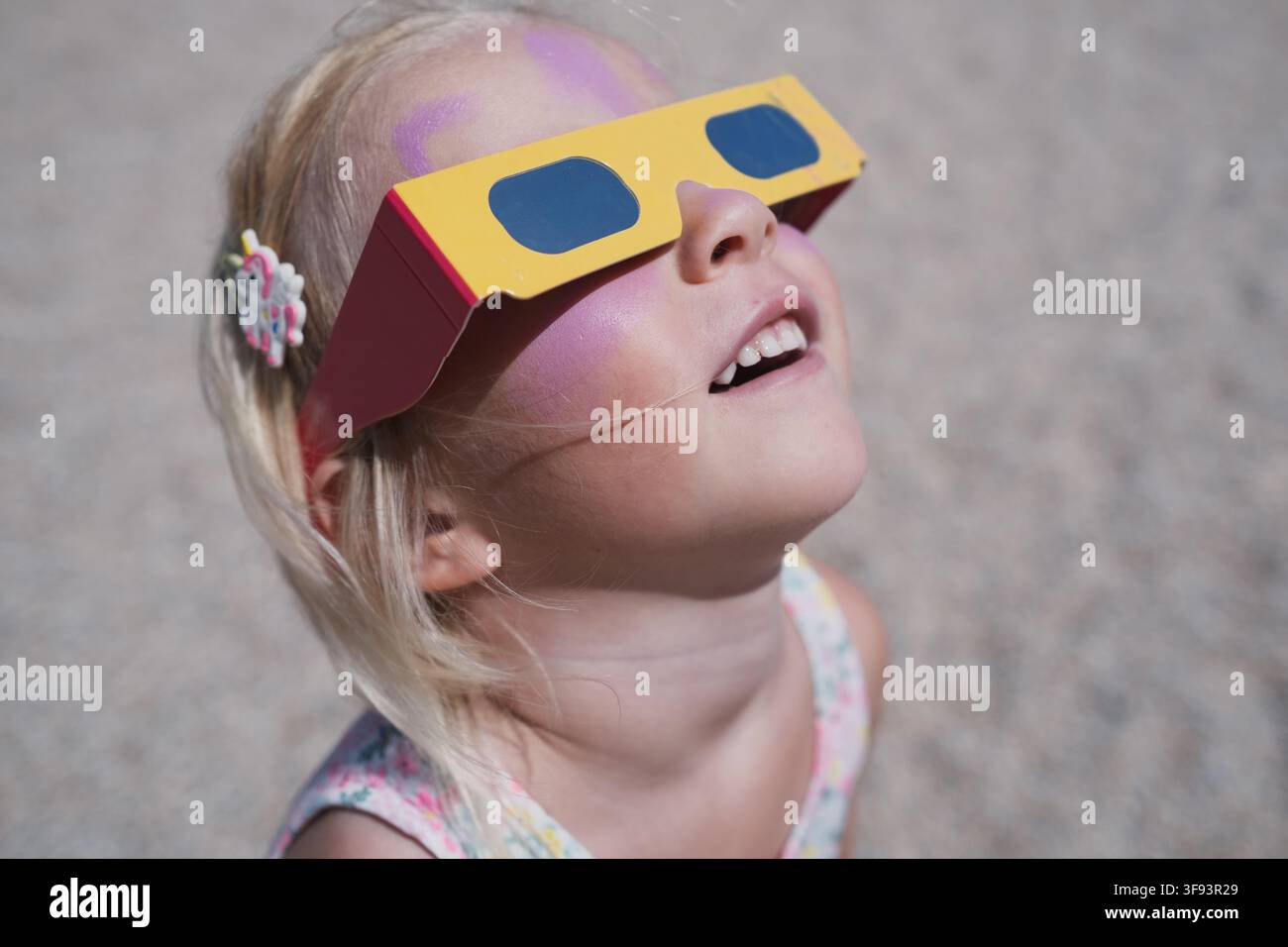 Girl Wearing Solar Eclipse Glasses Outdoors Stock Photo
