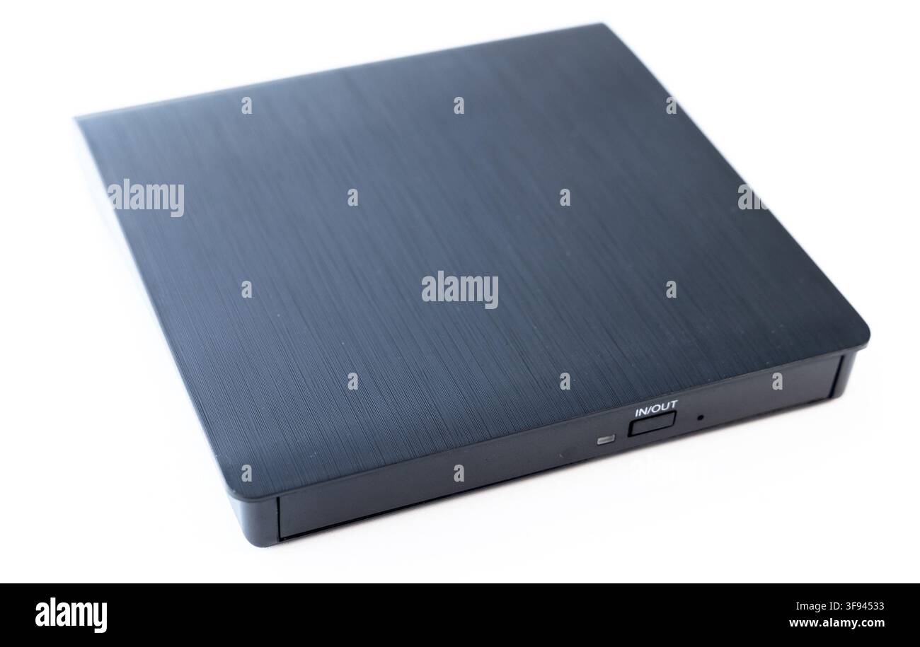 A sleek black external optical drive sits on a white background Stock Photo