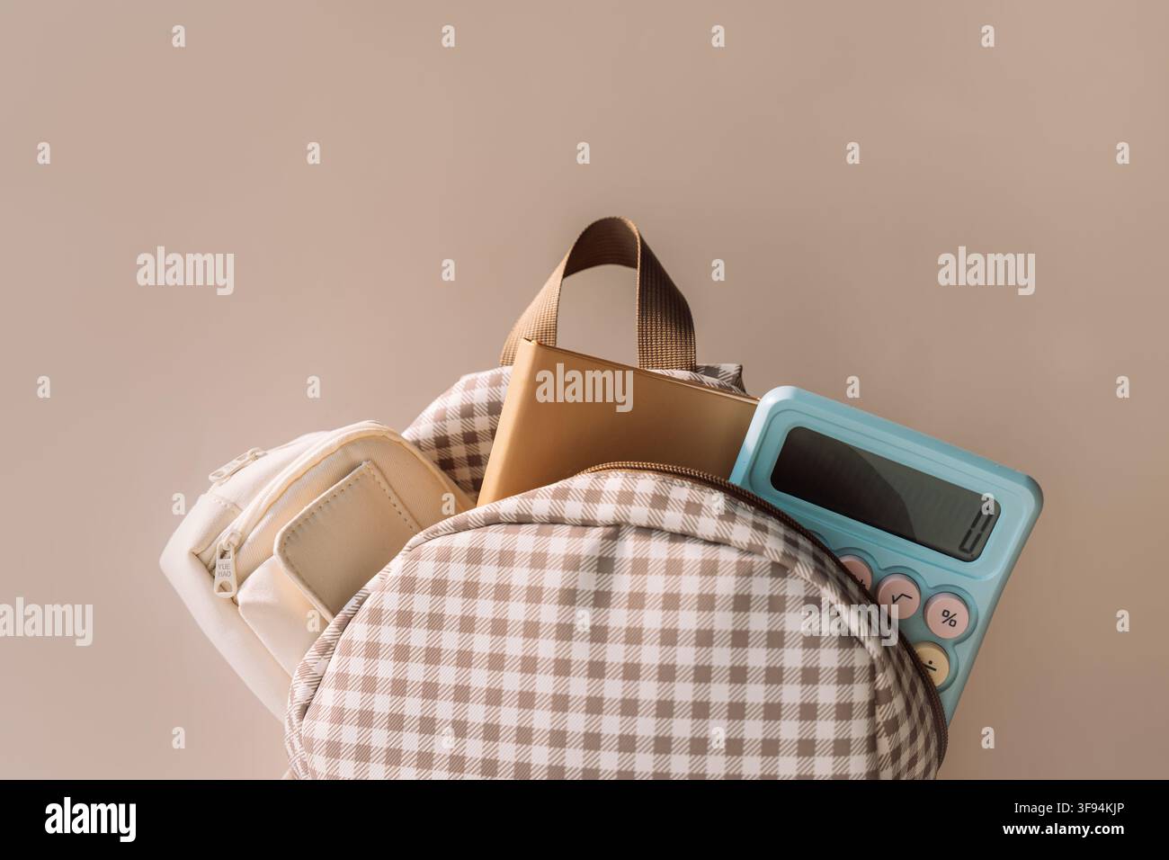 School backpack with notebook and blue calculator, stylish back to school background Stock Photo