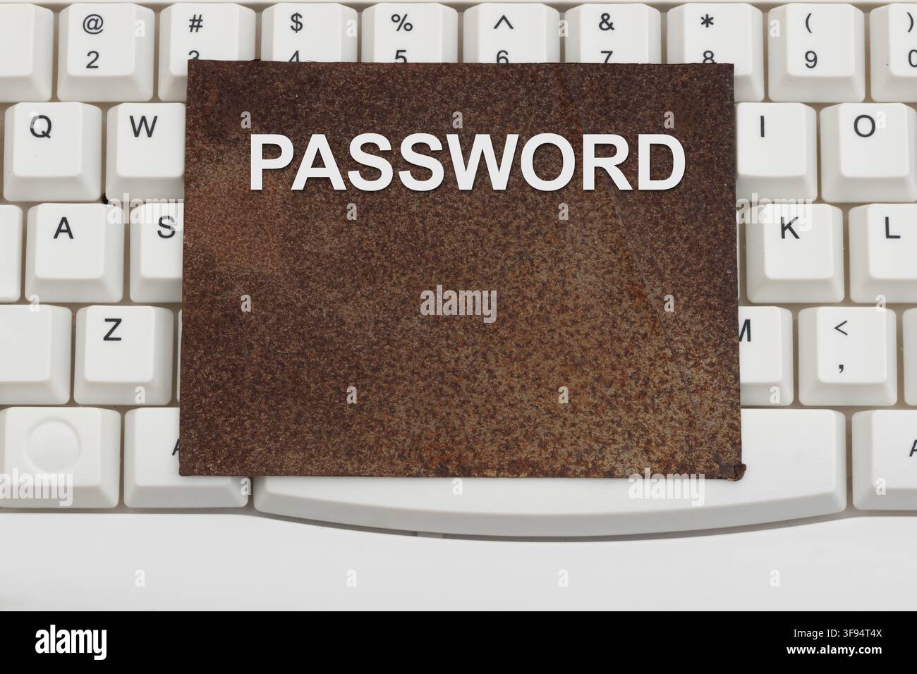 Password text rusty sign on a white computer keyboard for old and weak authentication Stock Photo
