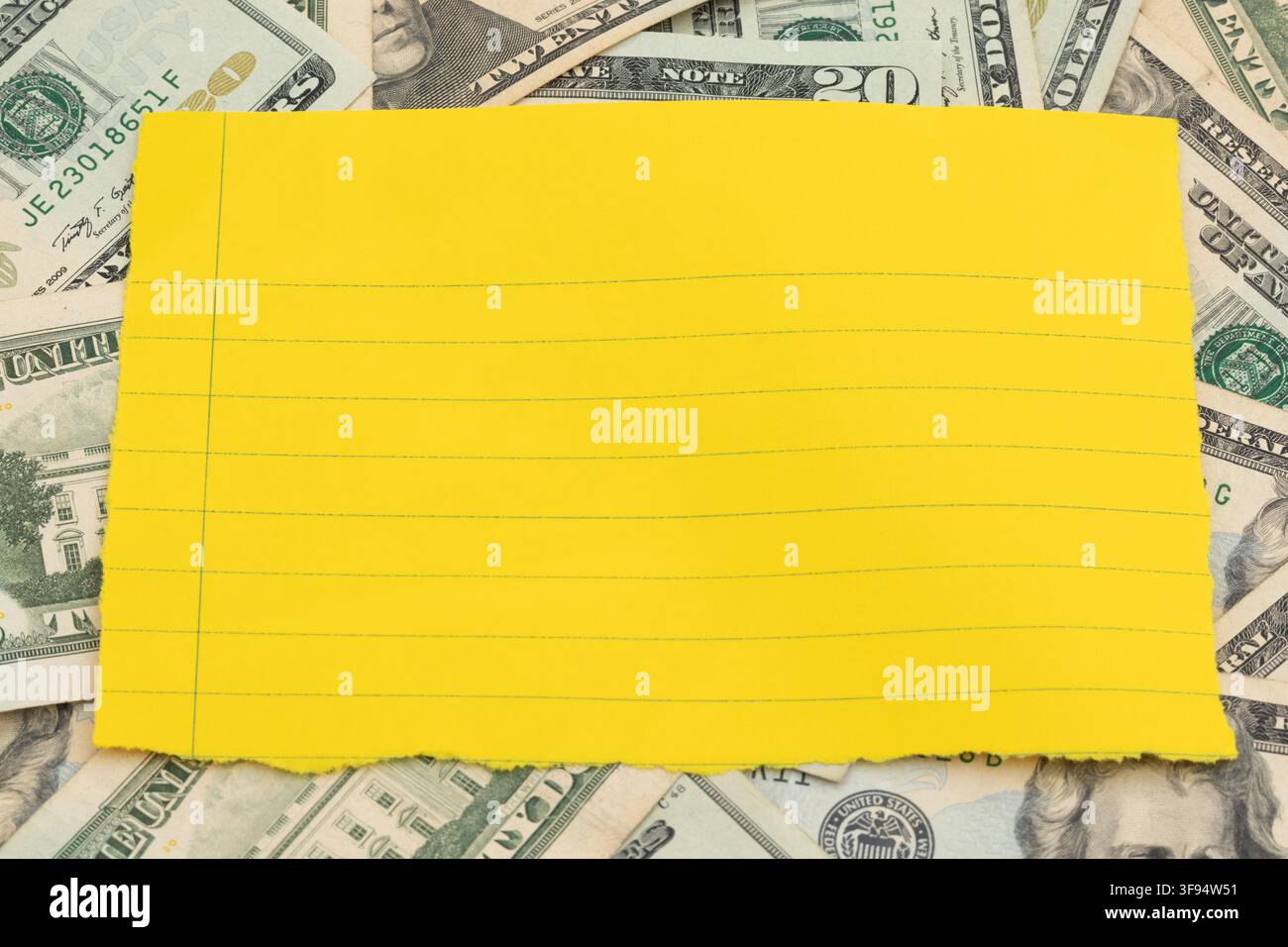 Blank lined paper on twenty dollar bills for personal budget planning Stock Photo