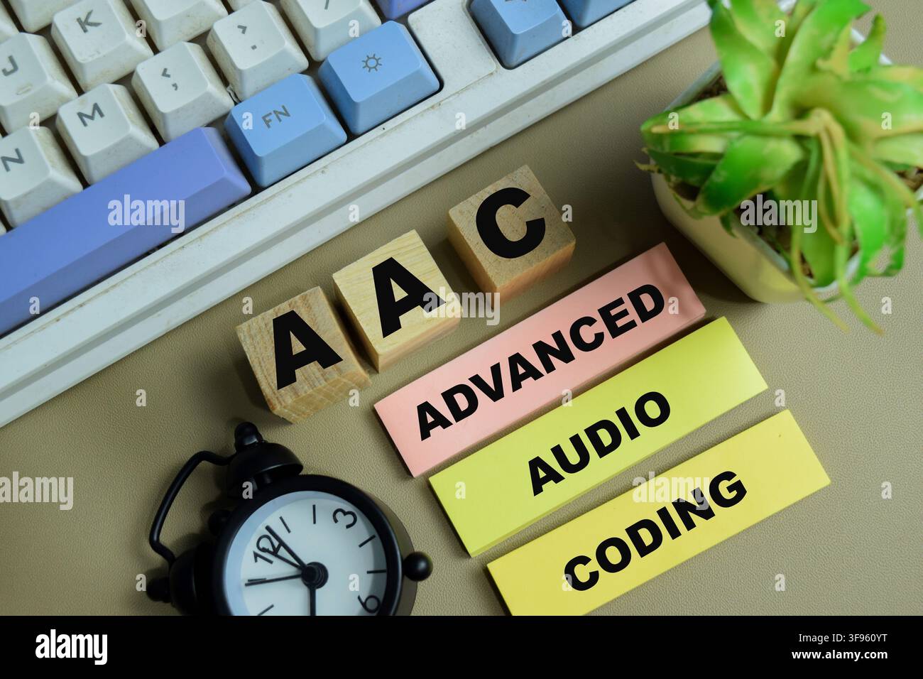 Concept of AAC - Advanced Audio Coding write on sticky notes isolated on Wooden Table. Stock Photo
