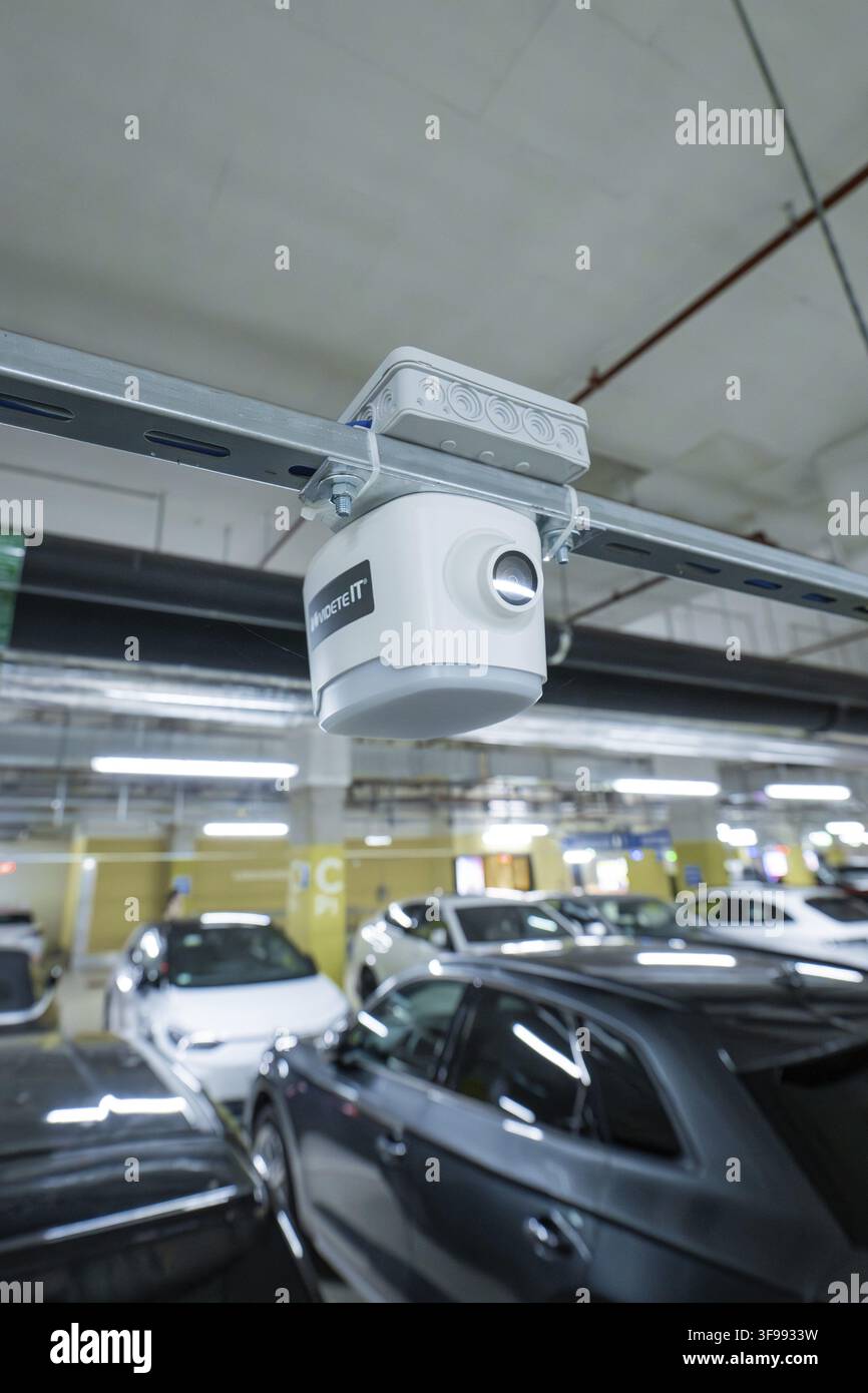 Security camera mounted on a rail above parked cars in a parking garage, Milaneo, Stuttgart, Germany Stock Photo