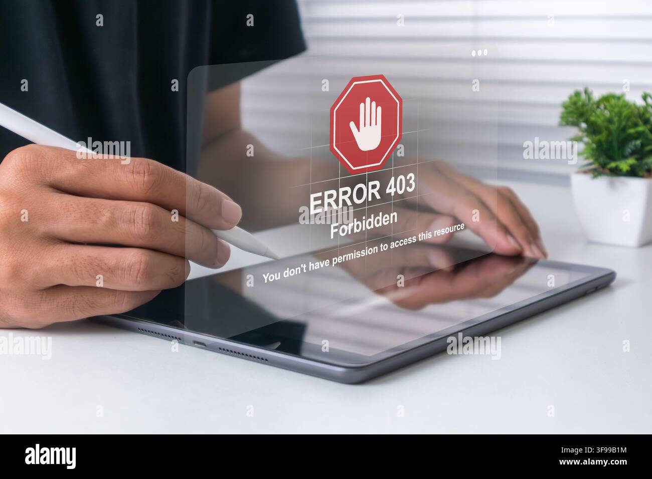 A man using a tablet computer with Error 403 message on screen. Error 403 Forbidden. Stock Photo