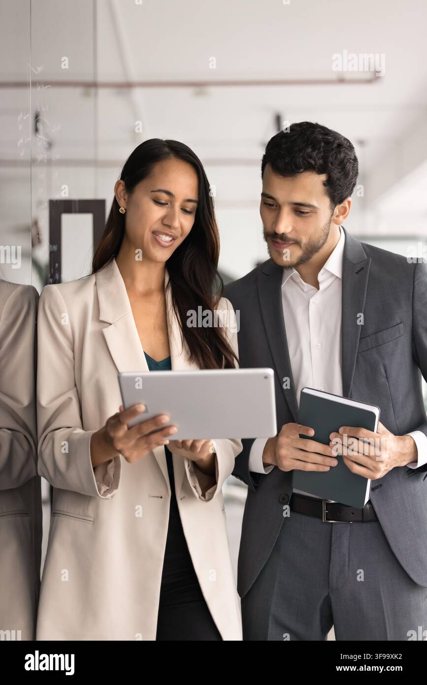 Two multiethnic team members reviewing new application on tablet Stock Photo