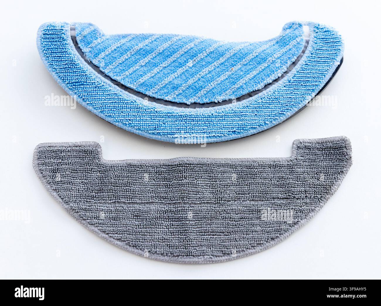 Two clean blue and grey microfiber mop pads on white background Stock Photo