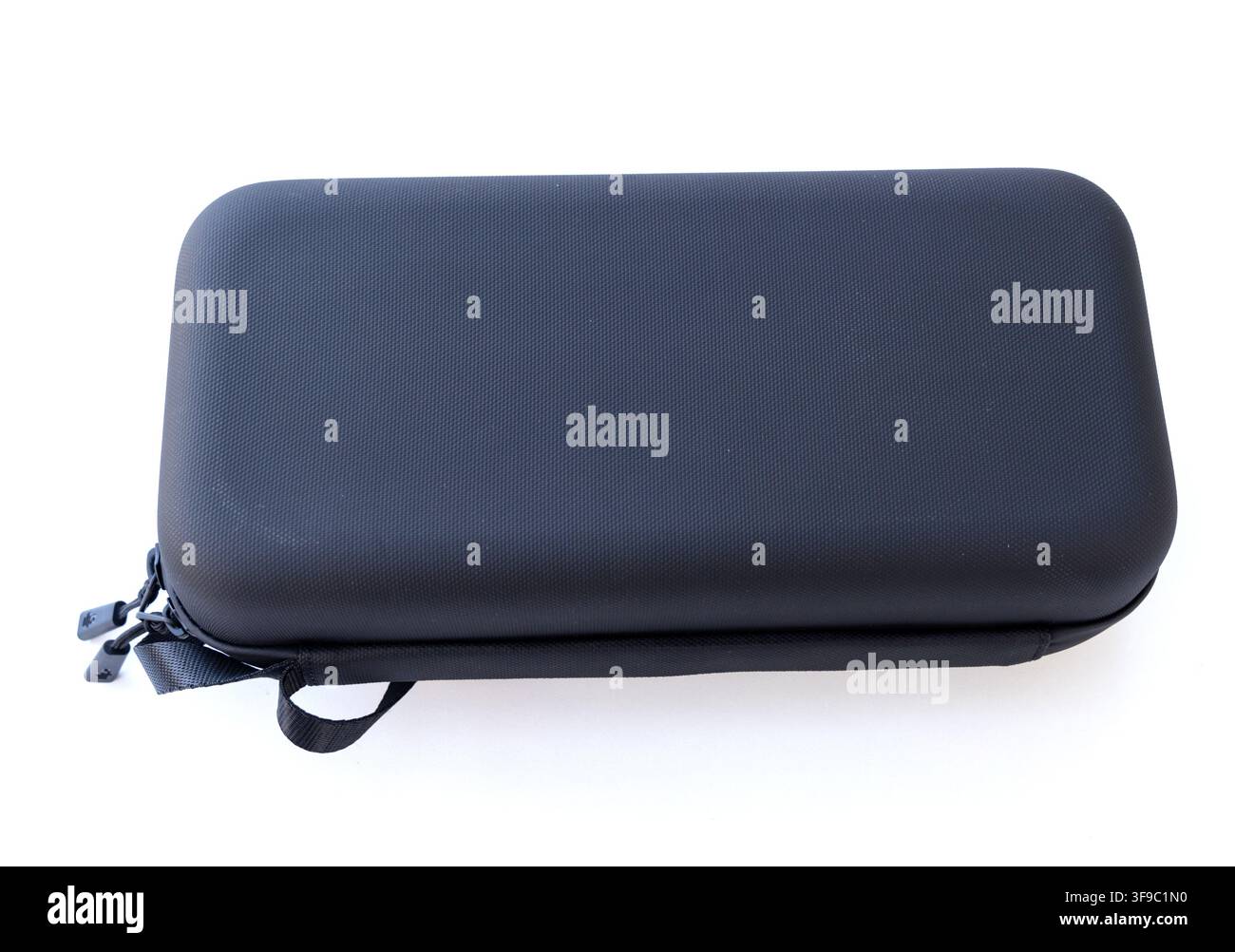 A rectangular black hard case with a zipper rests on a white background Stock Photo