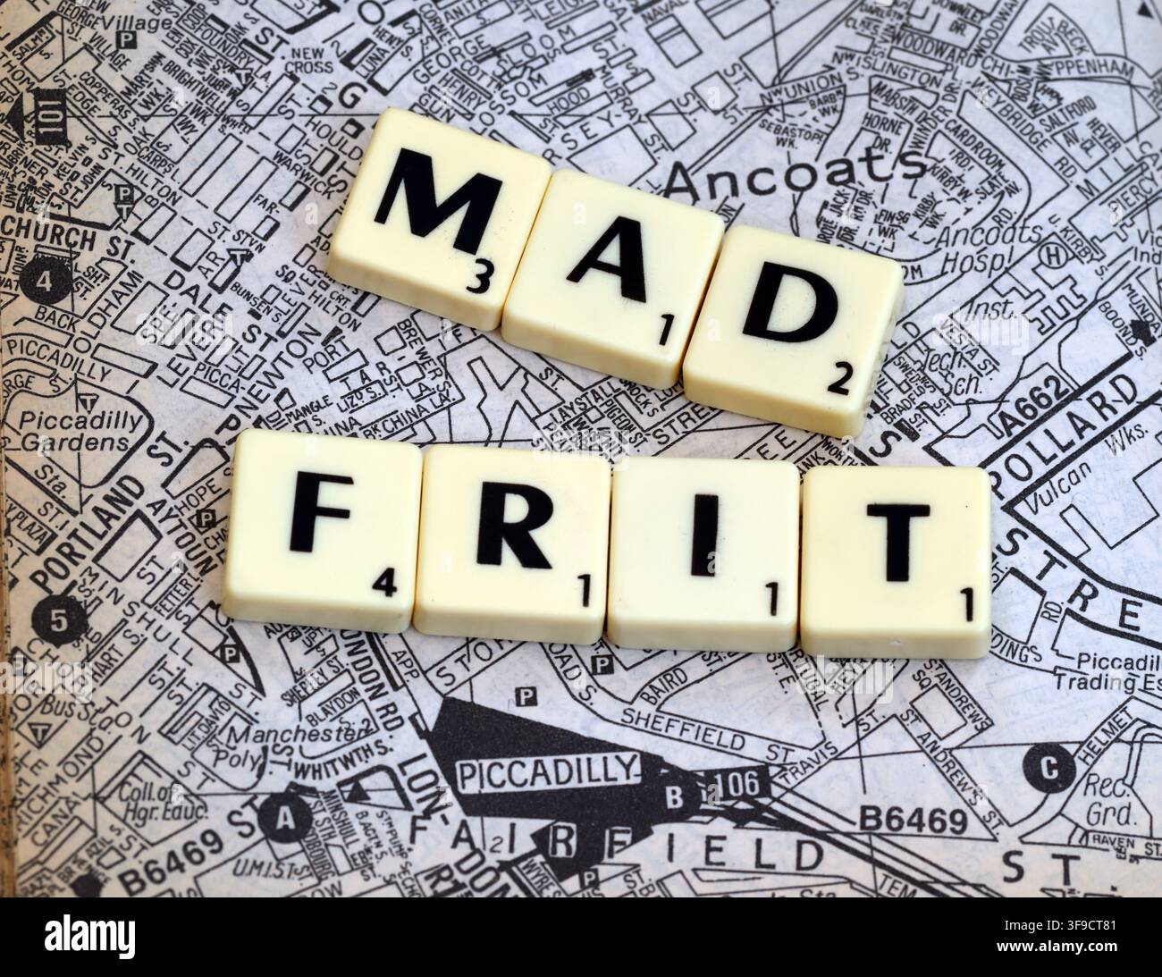 MadFrit Madchester-themed letter tiles over an Ancoats and Manchester street map, evoking Happy Mondays, the Hacienda and 1980s Mad Frit music Stock Photo