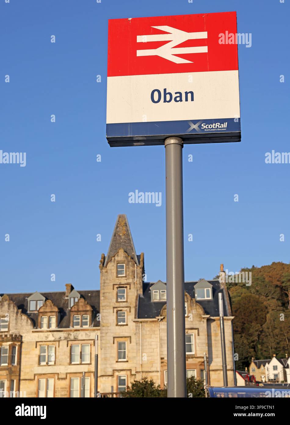 ScotRail Oban railway station sign with church tower behind, Scotland, UK. Stock Photo