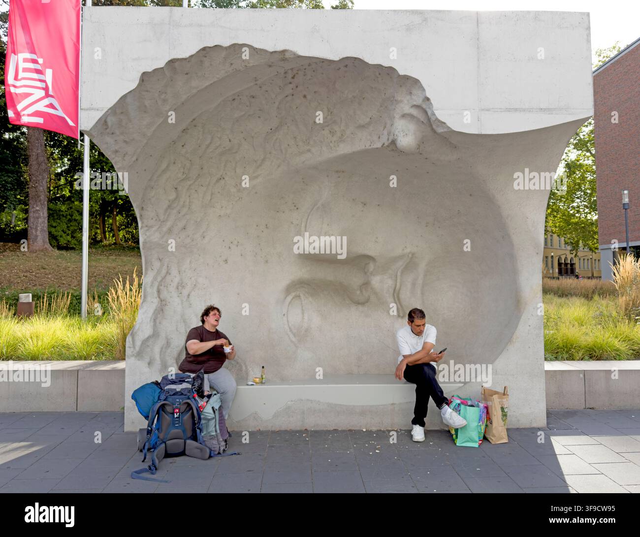 Large stone sculptural head and seating feature in Mainz Stadtpark, Germany. Stock Photo