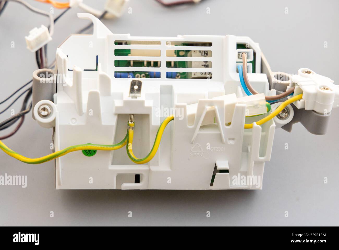 A white plastic electronic module with wires and a circuit board Stock Photo