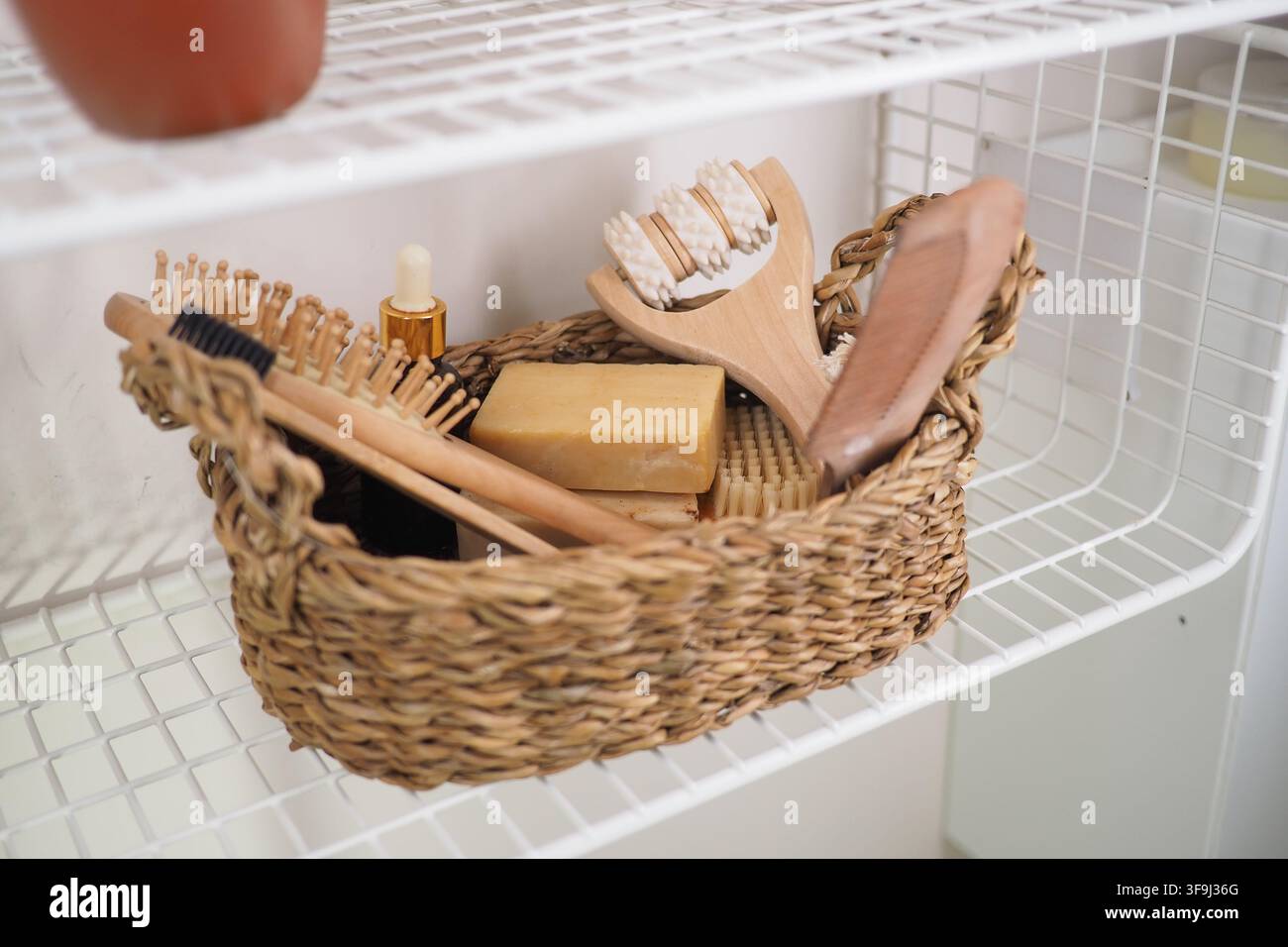 Basket with grooming tools on a white shelf Stock Photo