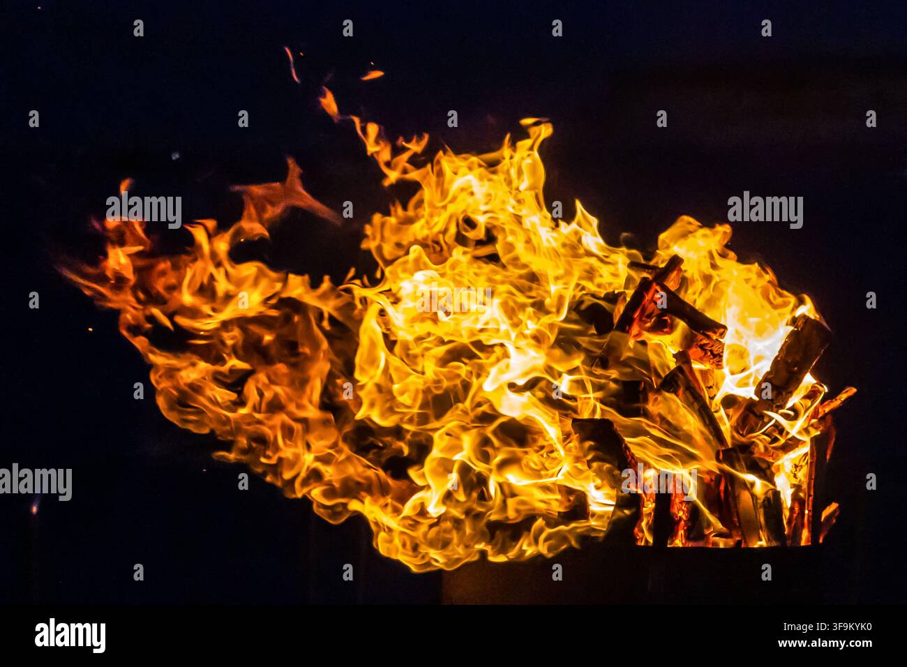 Close-Up Of Intense Wood Fire Flames And Burning Logs In Hot Orange Bonfire Stock Photo