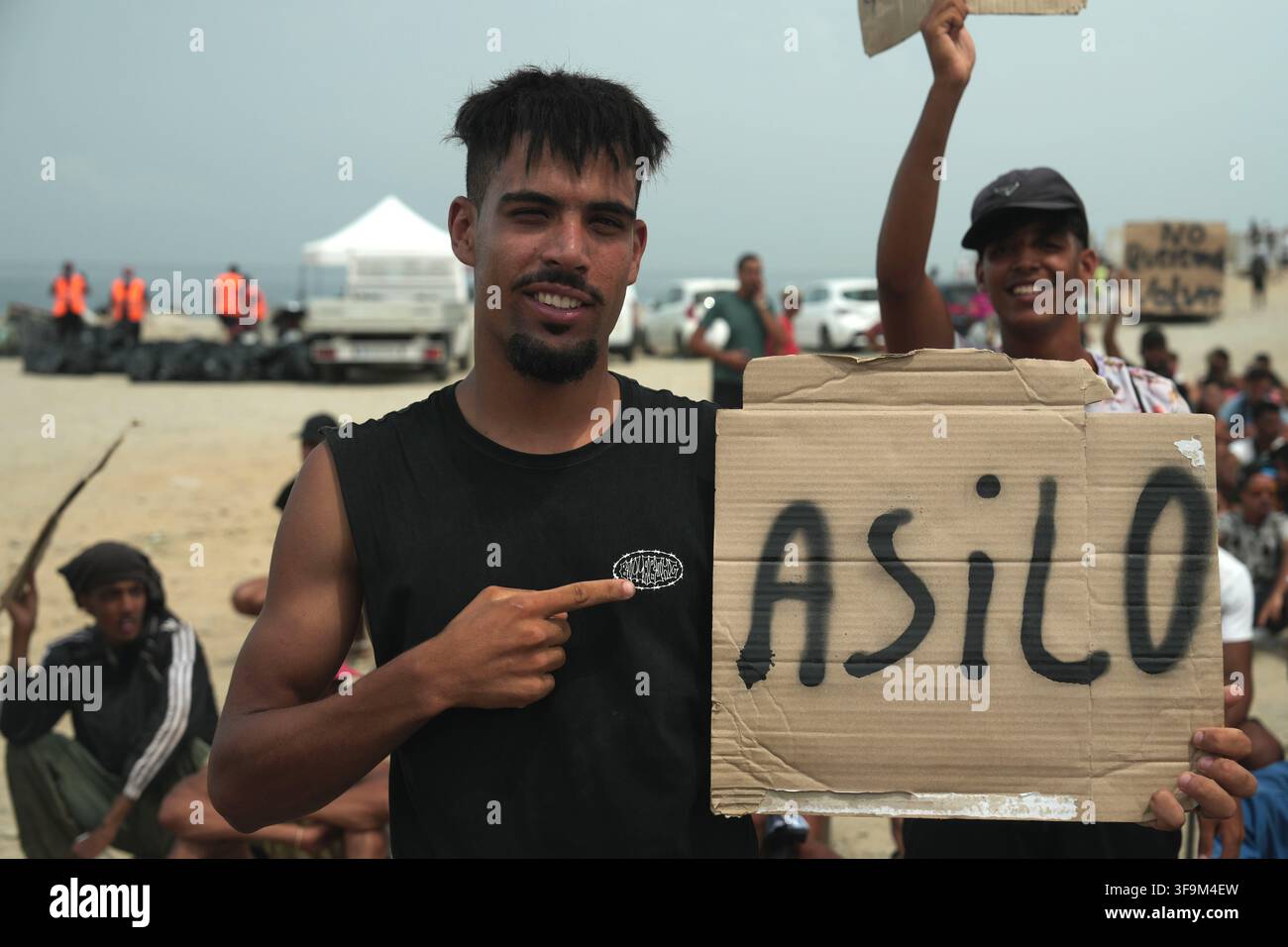 16 August 2026, Spain, Ceuta: Migrants are demonstrating on Playa Del ...