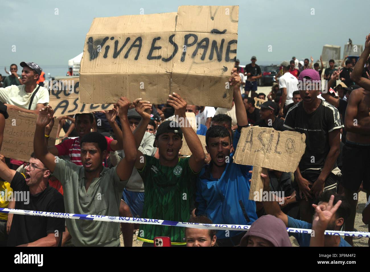 16 August 2026, Spain, Ceuta: Migrants are demonstrating on Playa Del ...