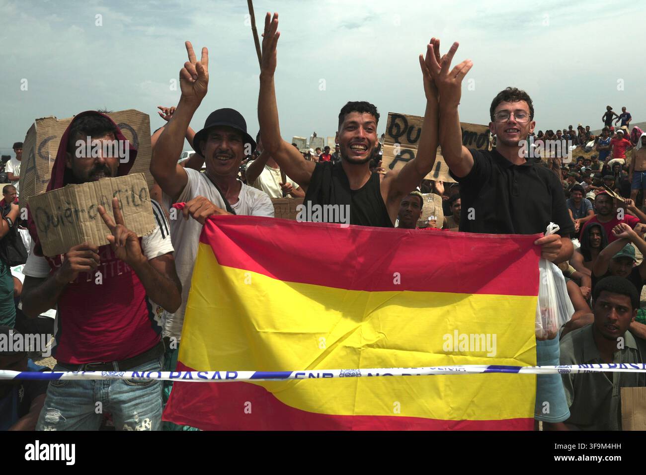 16 August 2026, Spain, Ceuta: Migrants are demonstrating on Playa Del ...