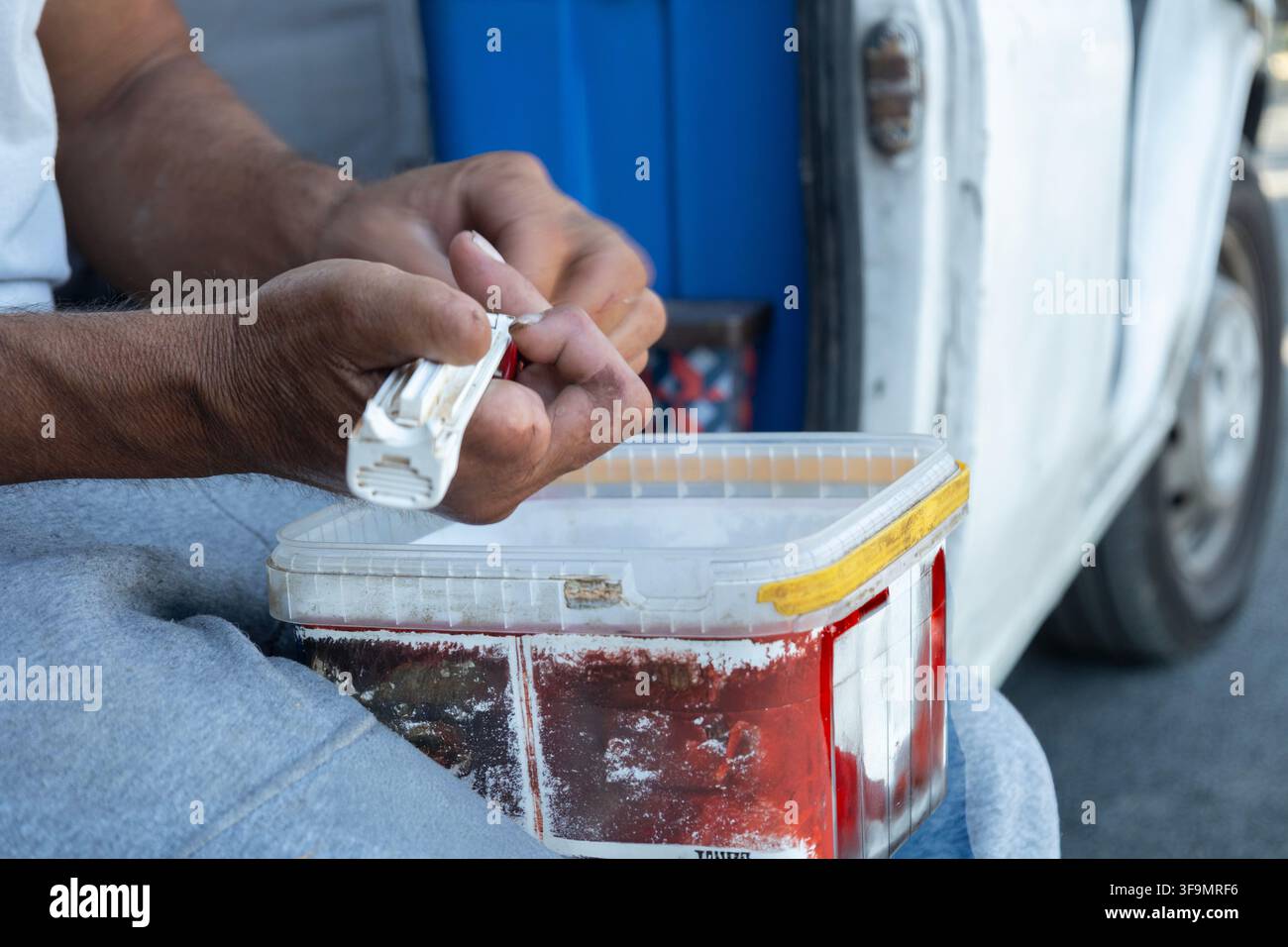 Worker hands using tools at a construction site Stock Photo