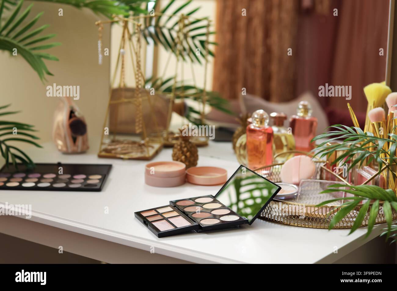 Makeup products on table in dressing room, closeup Stock Photo