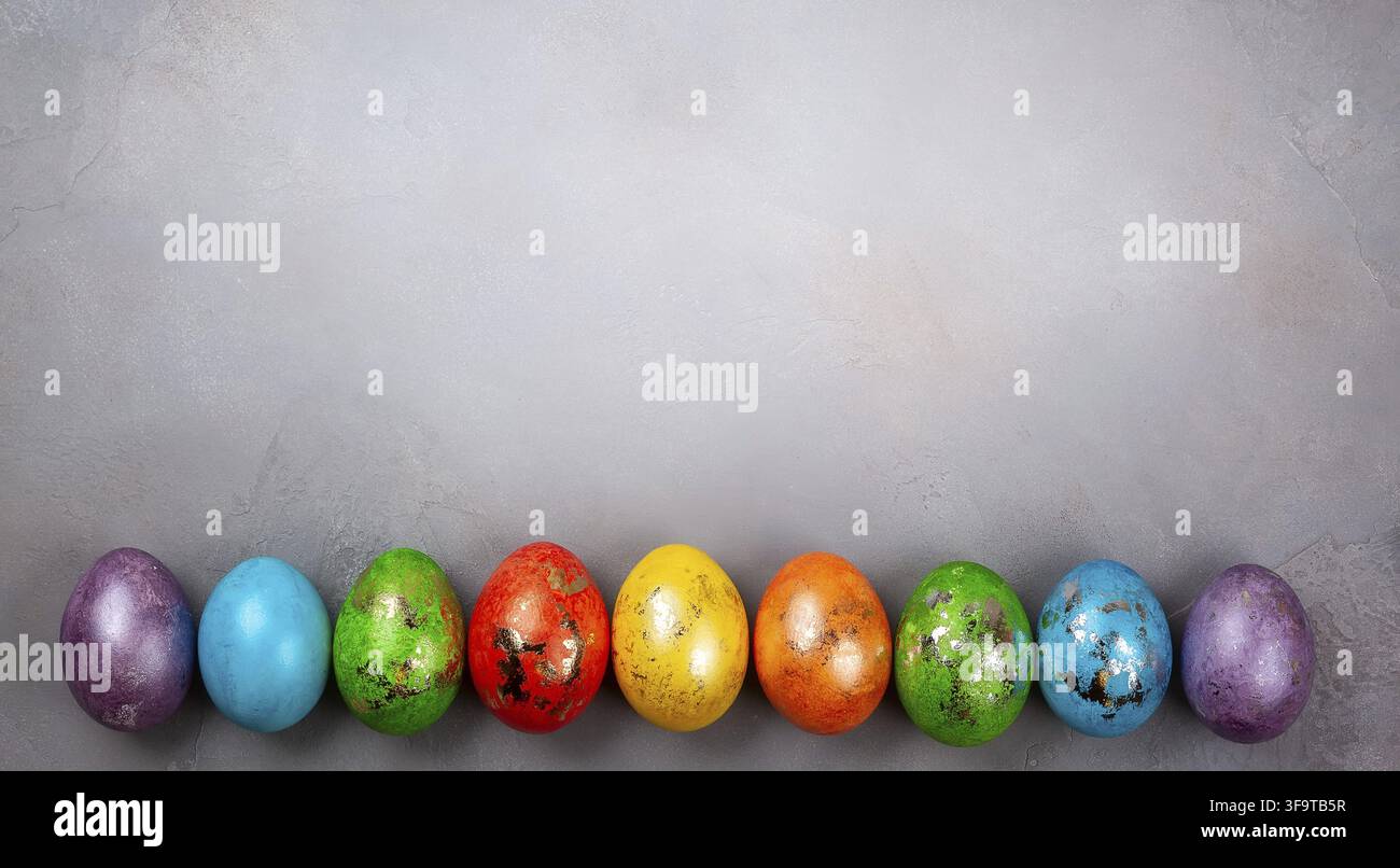 Easter concept wit colorful Easter eggs on grey background. Top view with copy space Stock Photo