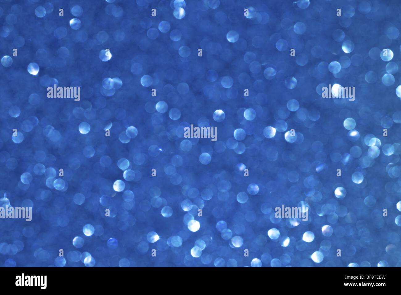 Vibrant Blue Bokeh Background with Shimmering Light Patterns Stock Photo