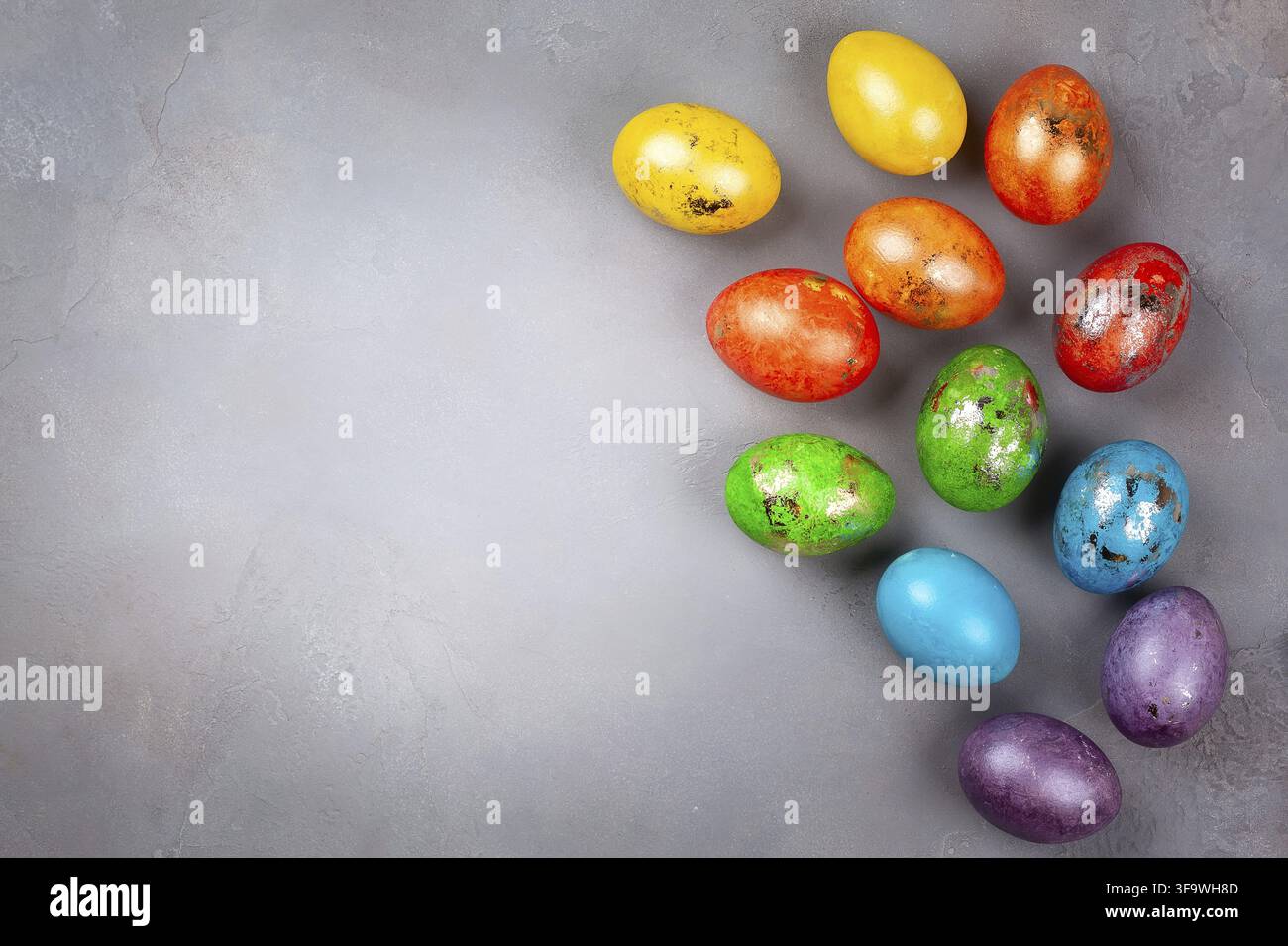 Easter concept wit colorful Easter eggs on grey background. Top view with copy space Stock Photo