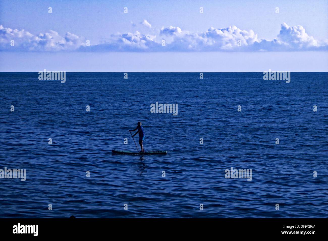 A beautiful phpto of a guy on boat in blue sea - Smartphone Captured Stock Image