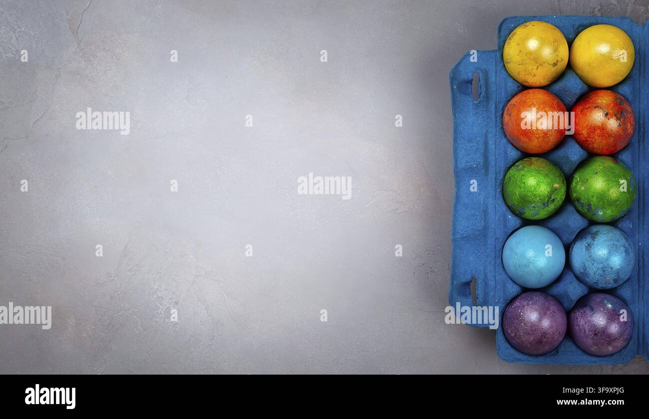 Easter concept wit colorful Easter eggs on grey background. Top view with copy space Stock Photo