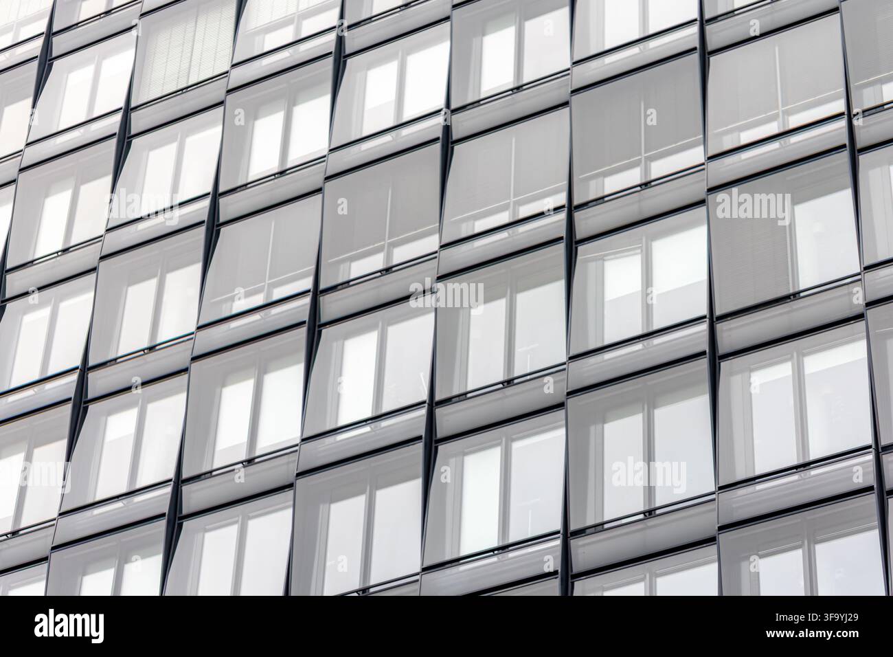 Modern glass facade with blinds. Repeating windows for design content. Stock Photo
