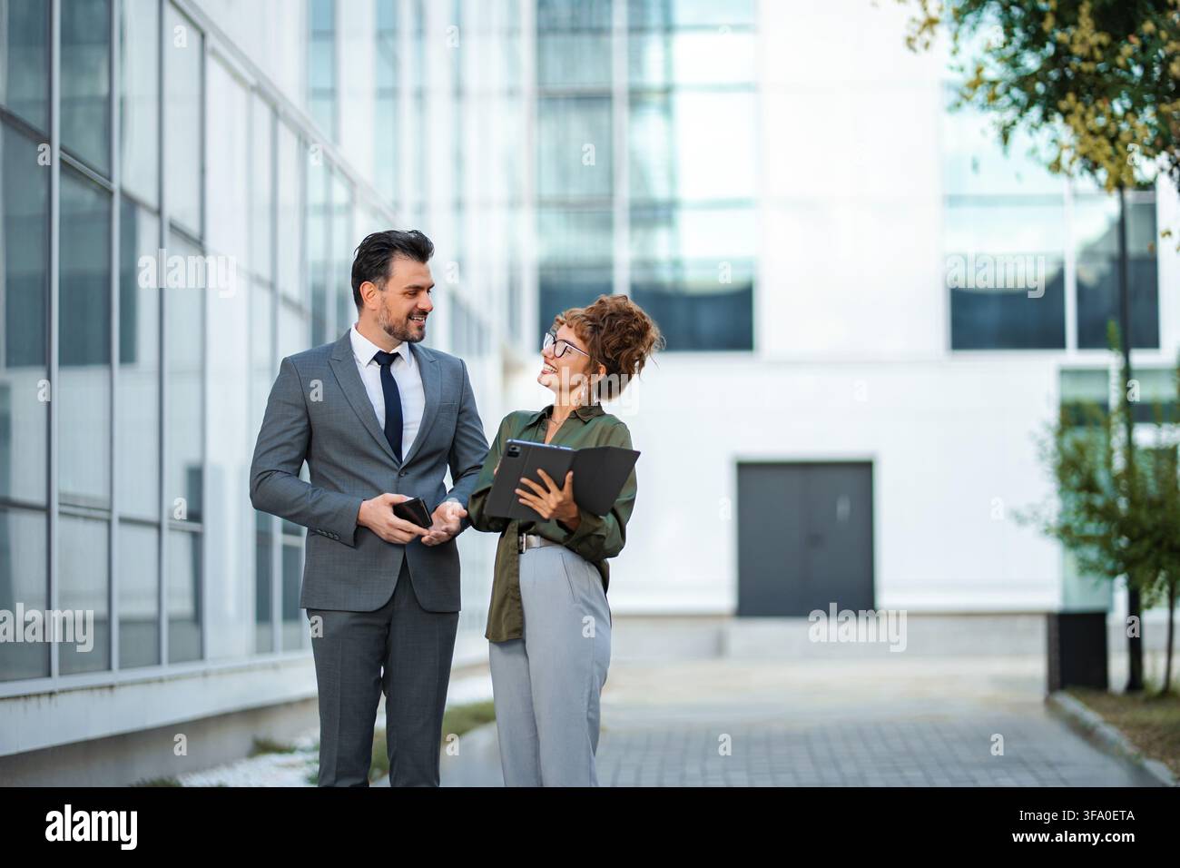 Business colleagues discussing project ideas outdoors Stock Photo