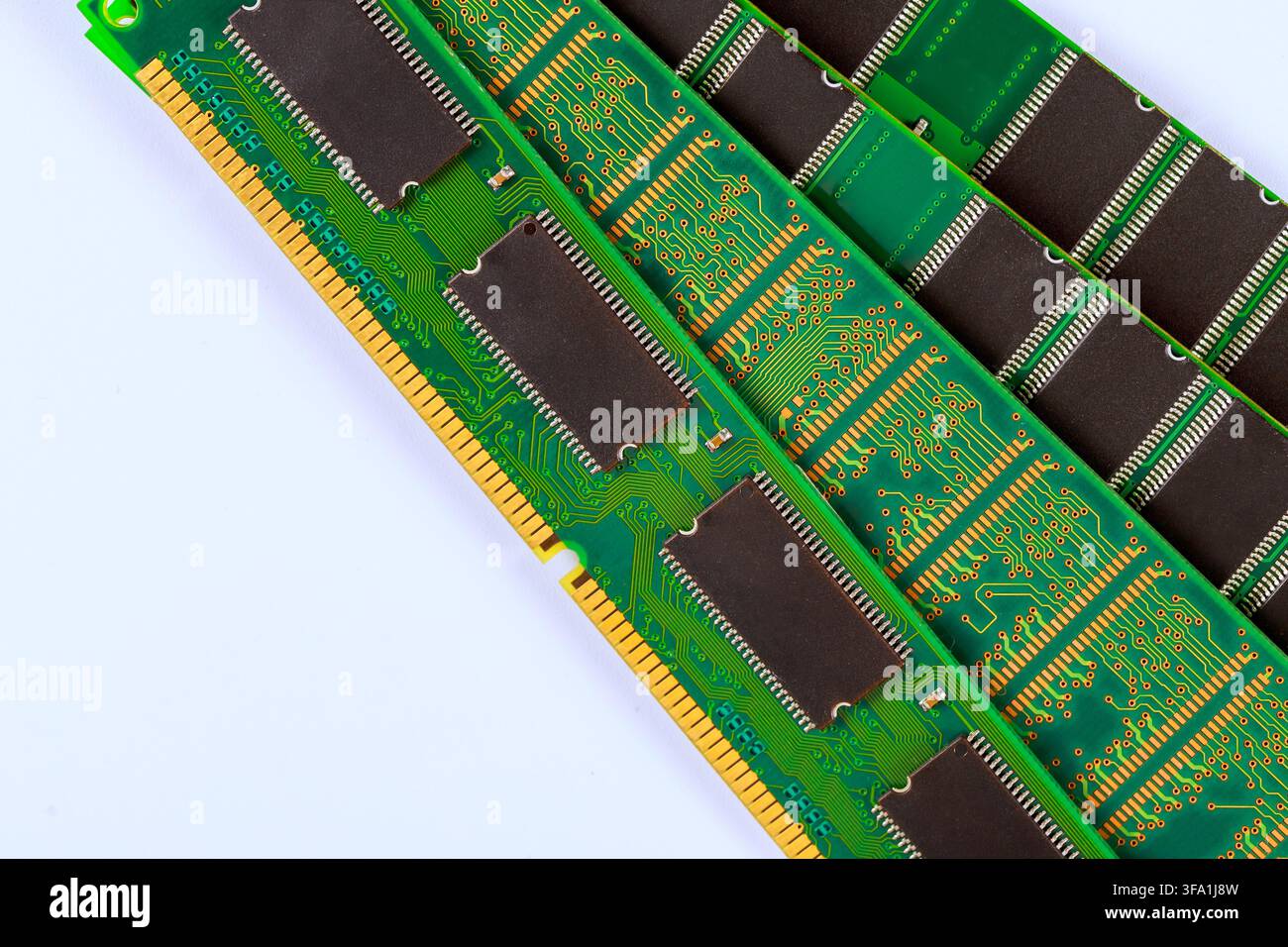 Several computer memory sticks lie on white surface green circuits dark chips arranged in rows. Stock Photo