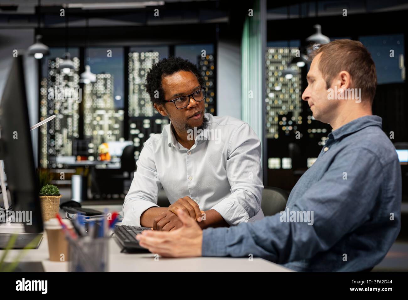 Technicians doing brainstorming, writing code, developing machine learning APIs. Colleagues working together to troubleshoot software errors using artificial intelligence, resolving system crashes Stock Photo
