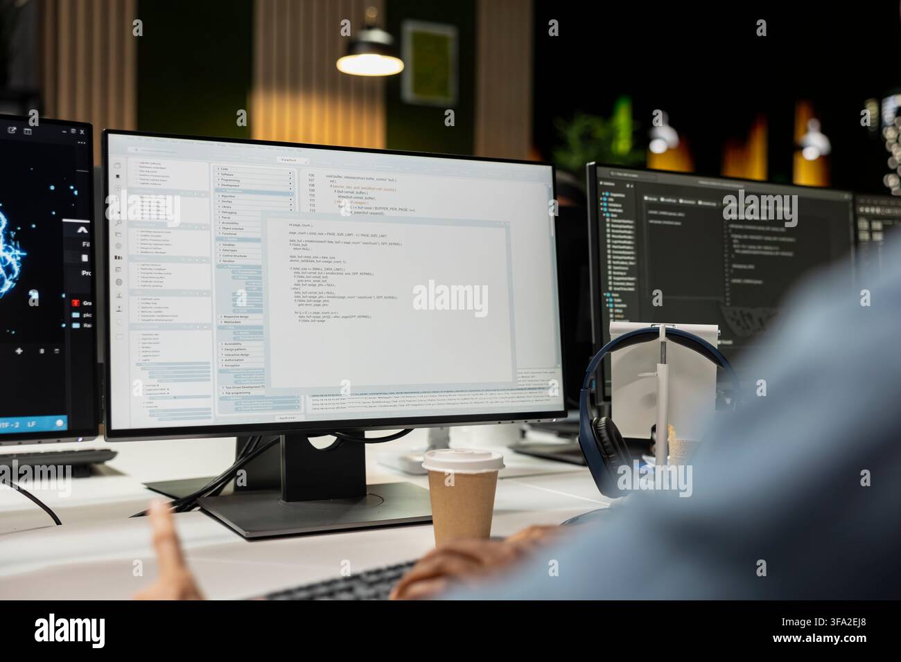 Close up of system administrator coding on PC in startup office, refining machine learning models to enhance automation. IT worker using coding platform on computer in technology company workplace Stock Photo