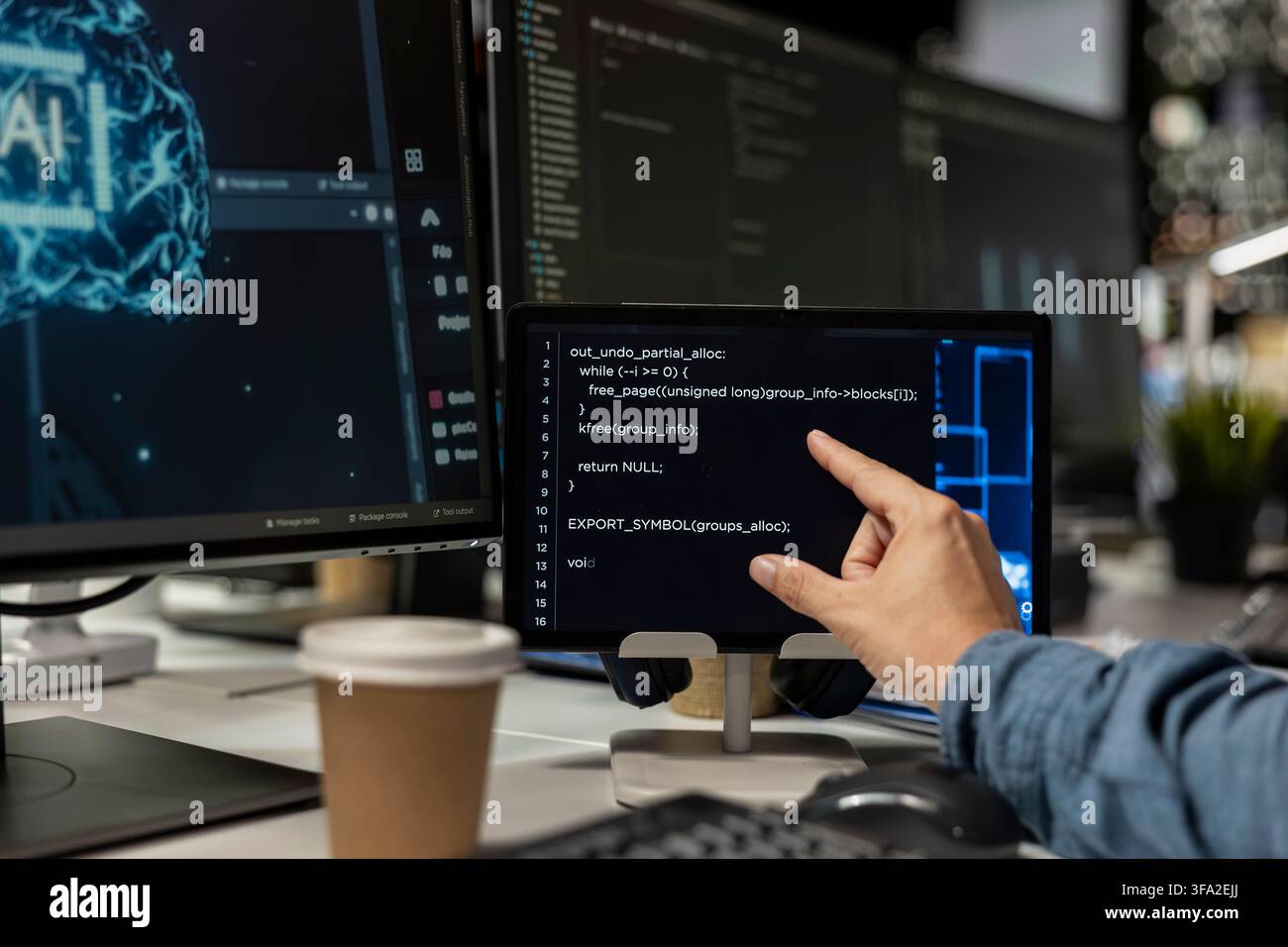 Close up of programmer using tablet in office, reviewing AI system metrics, monitoring performance dashboards. Technology company worker tuning neural networks using tools on device Stock Photo