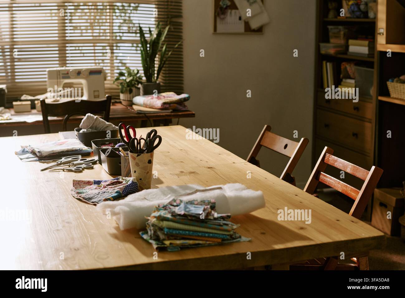 Empty Creative Sewing Workshop with Tools on Wooden Table Stock Photo