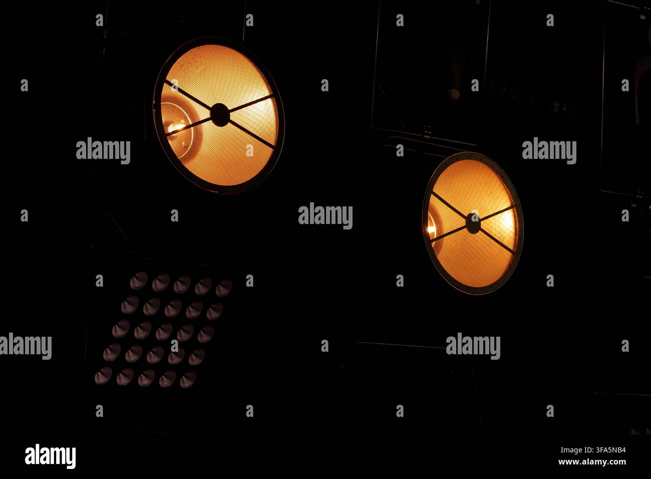 spot light projector lamps back stage equipment in the dark black background copy space pattern Stock Photo