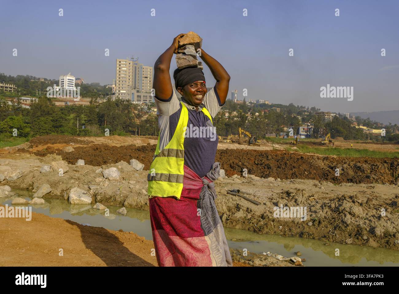 Worker carrying blocks on construction site in Kigali, Rwanda. Stock Photo