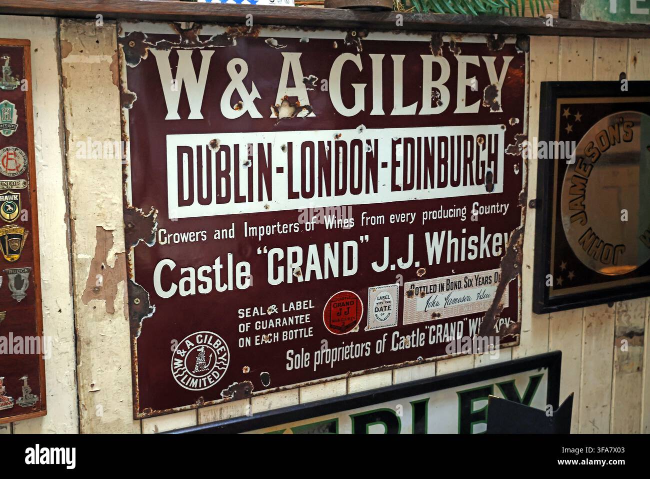 Historic W and A Gilbey whisky advertising sign in Tralee, Ireland Stock Photo