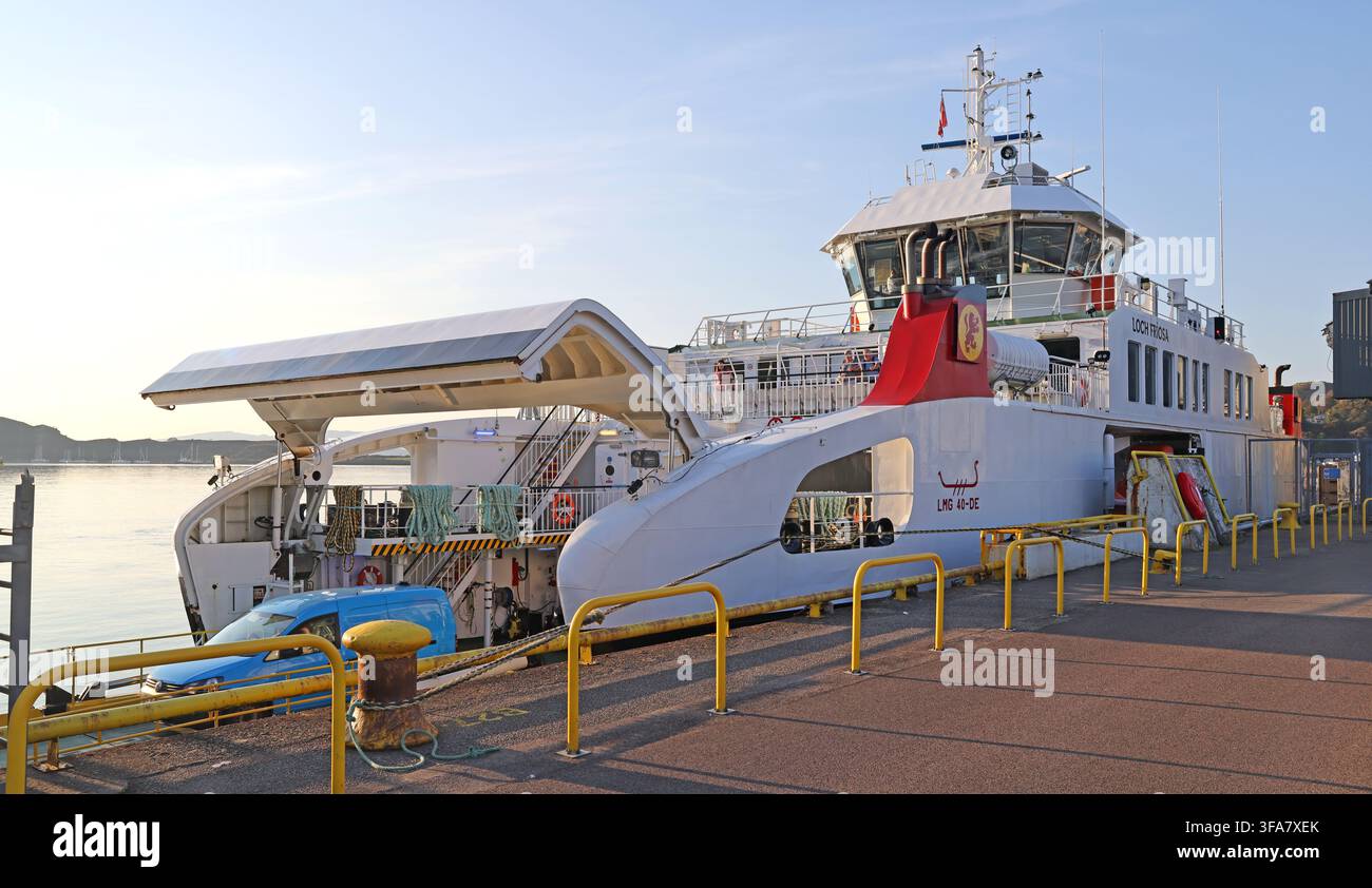 MV Loch Frisa CalMac vehicle and passenger ferry berthed at Oban Ferry Terminal, Argyll and Bute, Scotland, UK, unloads cars & vans at sunset Stock Photo