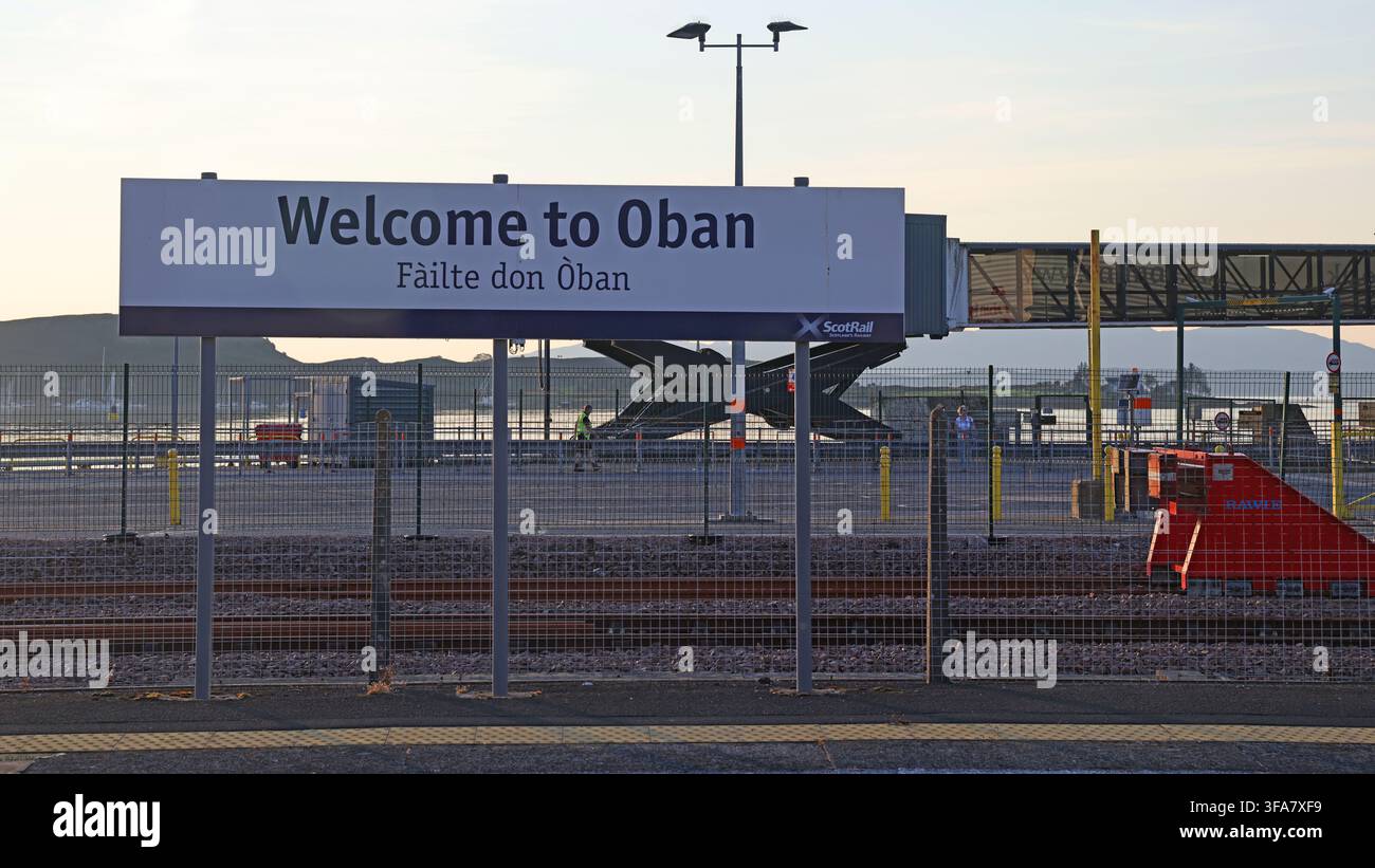 Welcome to Oban railway station sign , ferry terminal, at dusk in Argyll, Scotland Stock Photo