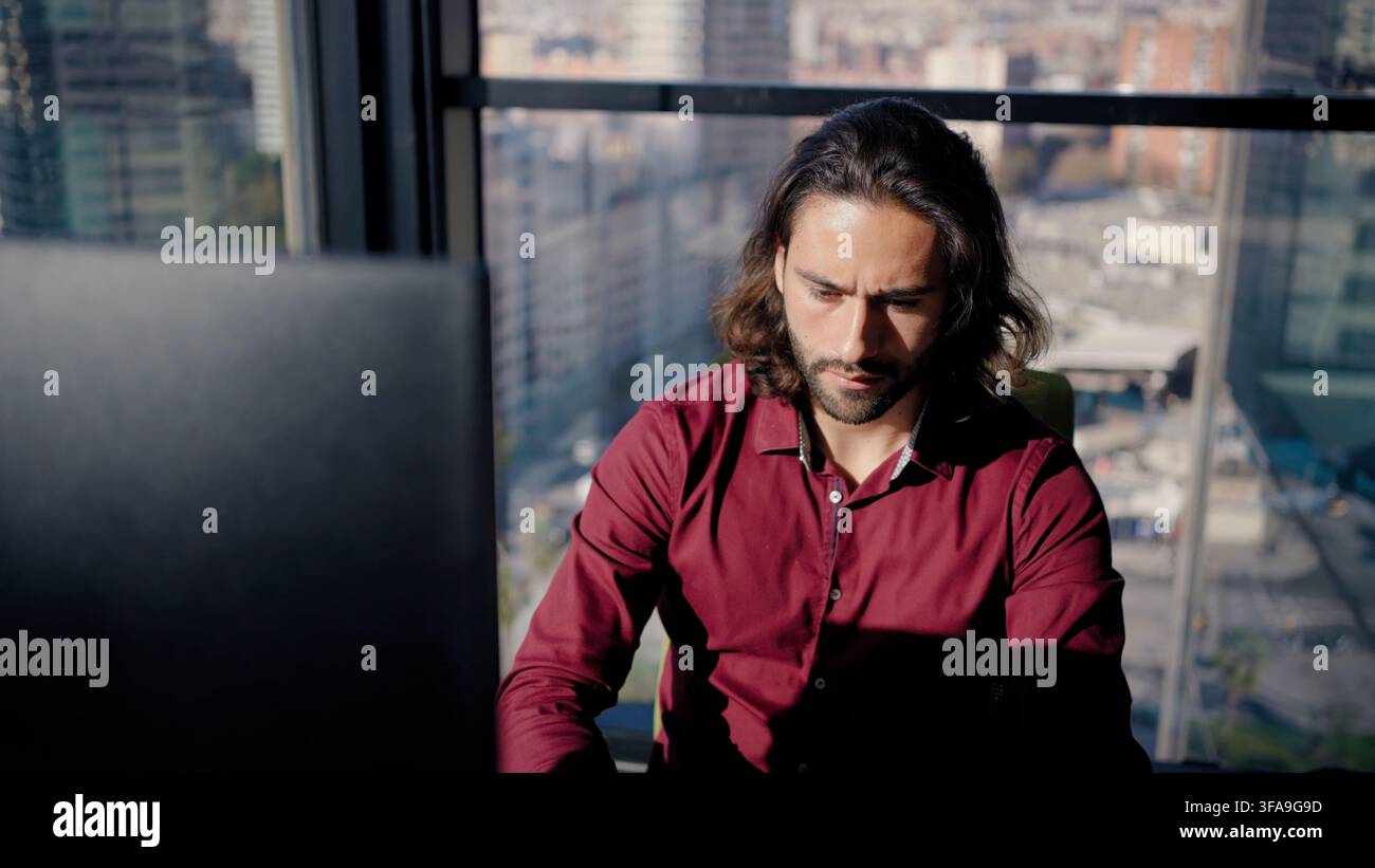 Focused man working on laptop in office Stock Photo