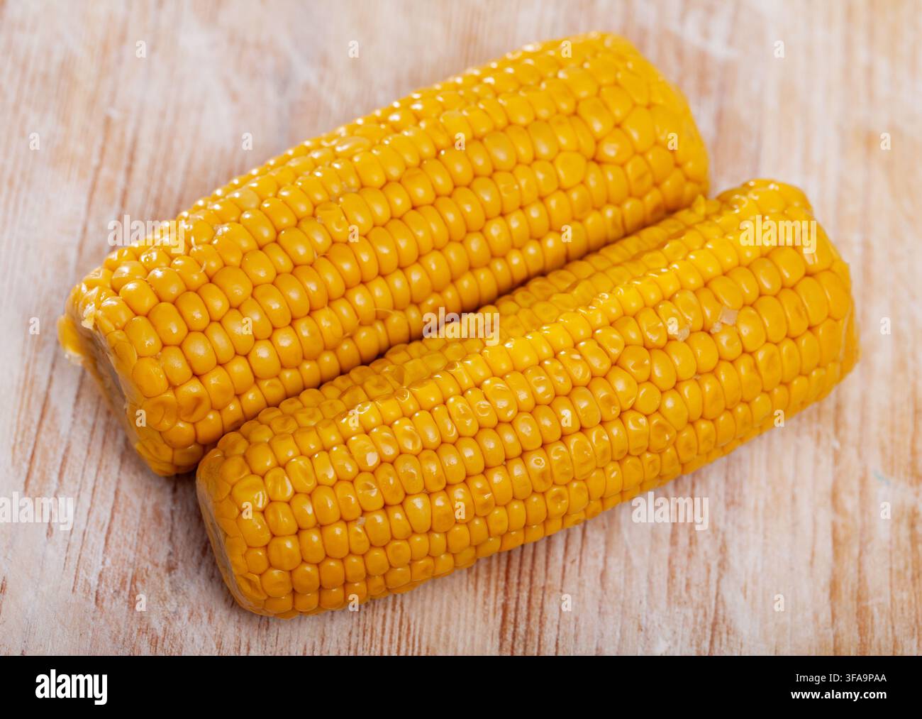Boiled sweet corn on wooden table Stock Photo