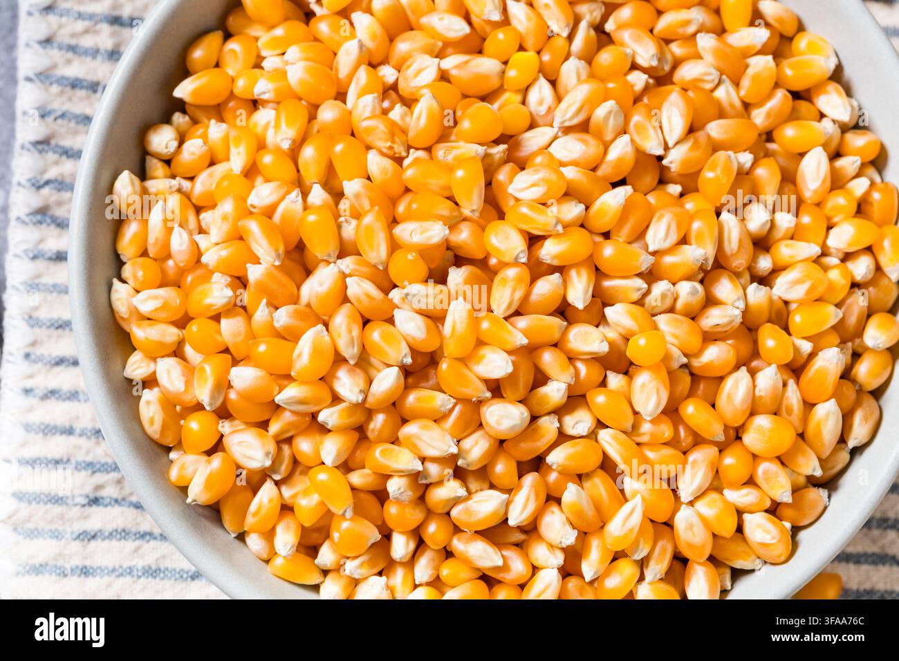 Dry Organic Raw Pop Corn Kernels in a Bowl Stock Photo